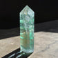 Green fluorite crystal tower on a slab back view