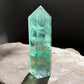 Green fluorite crystal tower on a slab front view