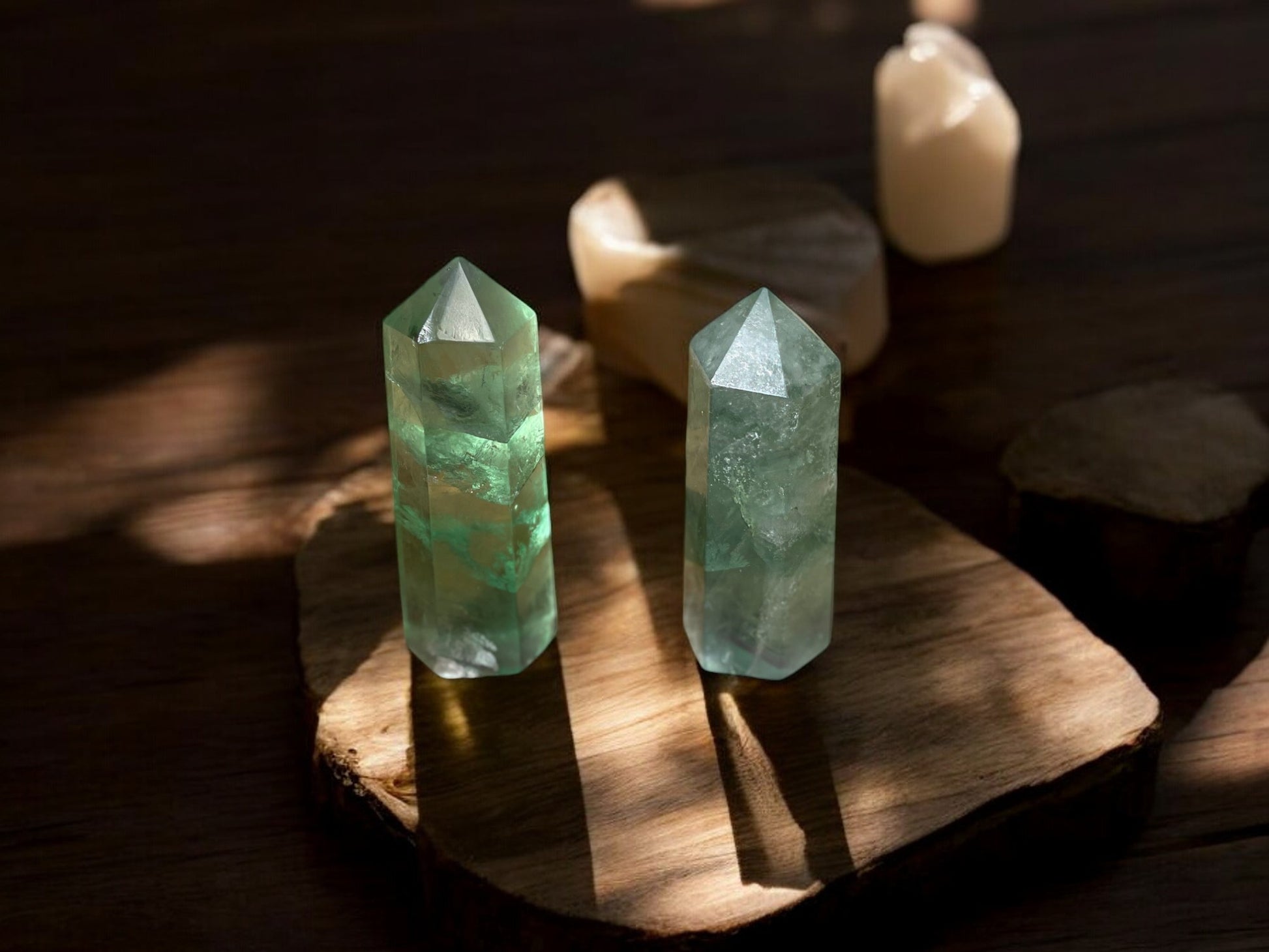 Variety of green fluorite crystal towers on a wooden slab