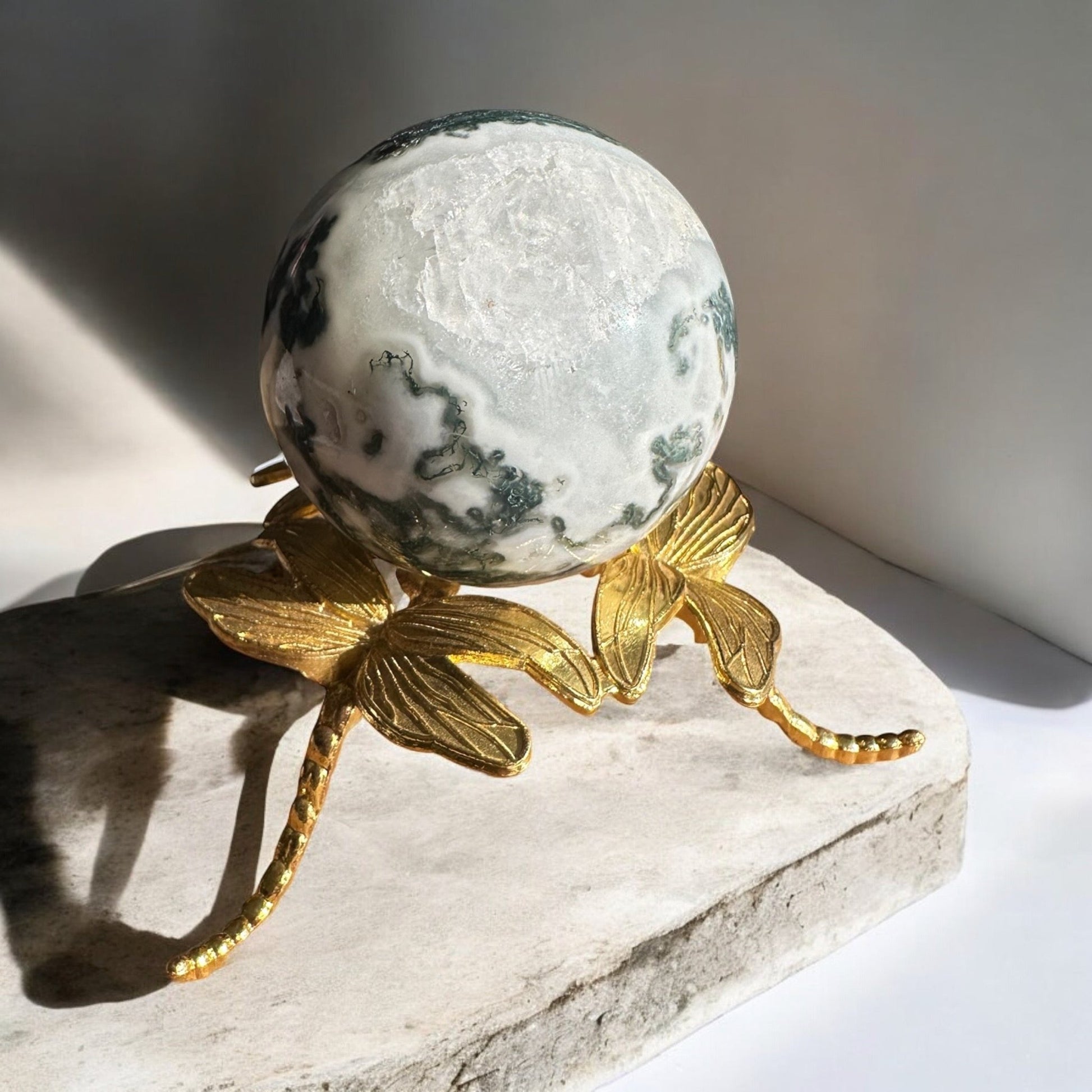 moss agate crystal sphere crystal on a stand