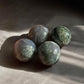 moss agate mini crystal spheres on concrete