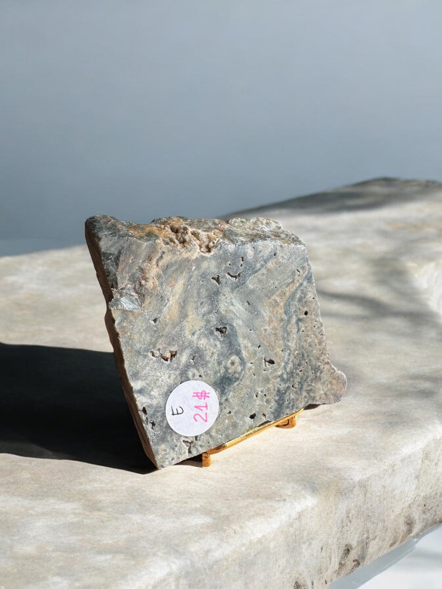 Ocean jasper crystal slab on a golden stand