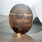 Smoky quartz worry stone in sunlight