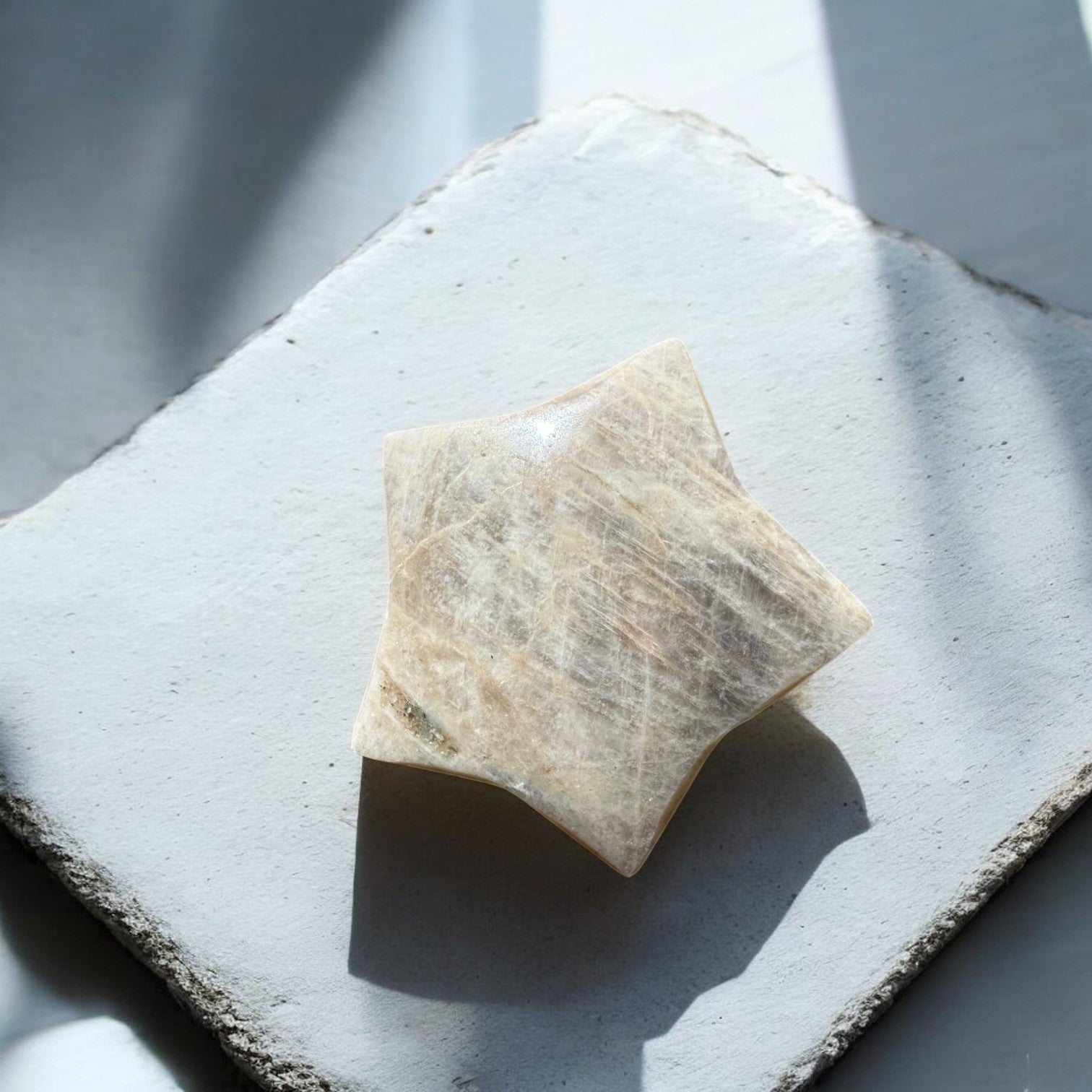 Sun stone in moonstone crystal star with blue flash