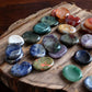 Worry stones on a wooden slab